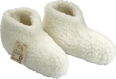 A pair of white, fluffy slippers on a white background.