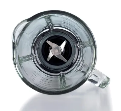 A close-up, top-down view of the blades inside a blender jar.