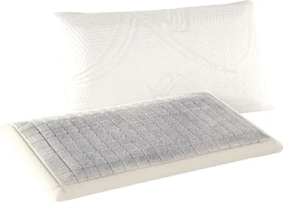 A pillow with a removable cover is shown, with the inner pillow exposed to reveal a textured surface.