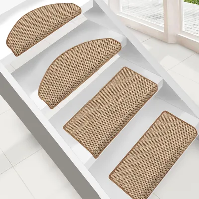 Several stair mats are placed on white stairs.