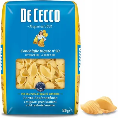A package of De Cecco pasta with a window showing the product, and two pieces of pasta shown separately.