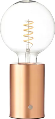 A clear, studio shot of a copper-based LED table lamp with a clear Edison-style bulb.