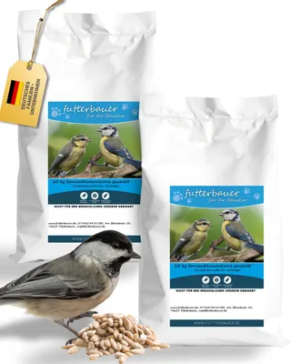 Two bags of birdseed with a bird and a pile of seeds in the foreground.