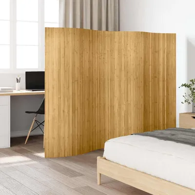 A room divider is placed between a desk area and a bed.
