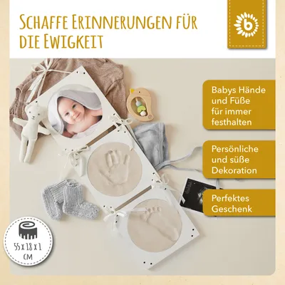 A baby hand and footprint mold kit is displayed with a baby photo, baby socks, and a baby toy.