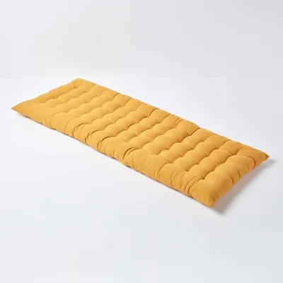 A yellow bench cushion on a white background.