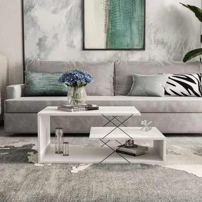 A modern living room scene with a white coffee table in front of a gray couch.