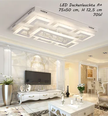 A modern living room with a large TV, a white entertainment center, and a decorative coffee table. A stylish LED ceiling light is prominently displayed overhead.