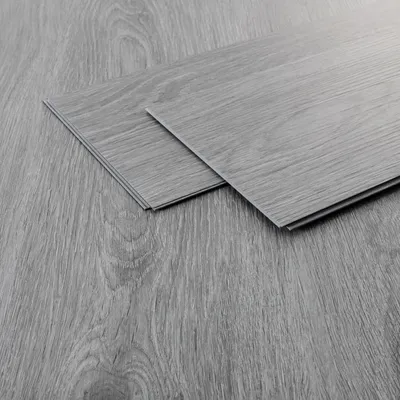 Two vinyl flooring planks are shown on a matching floor.