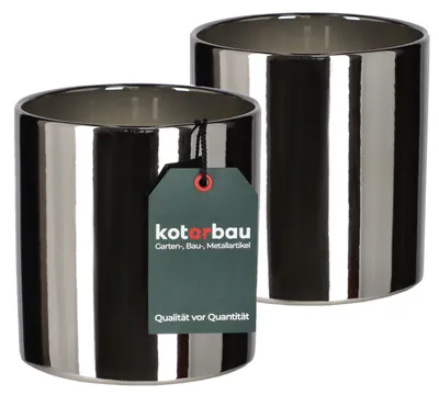 Two shiny cylindrical planters are shown side-by-side on a white background. One planter has a dark green tag attached to it.