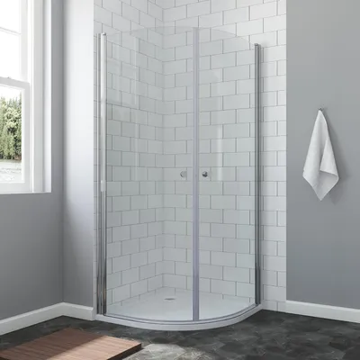 A modern bathroom with a corner shower enclosure.