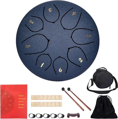 A steel tongue drum and its accessories are laid out on a white background.