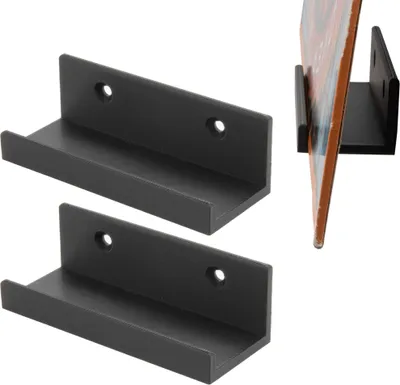 Two black wall mounts for vinyl records are displayed against a white background, with a third mount showing a record in use in the upper right corner.