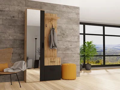 A modern entryway with a compact wardrobe set, mirror, and a chair, set against a concrete wall and large windows overlooking a scenic landscape.