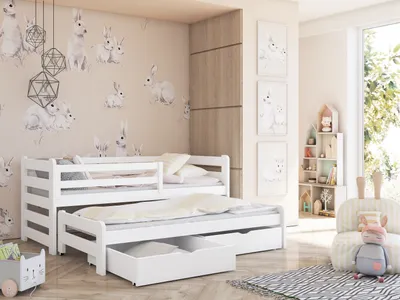 A child's bedroom with a white bunk bed with a pull-out bed and drawers, decorated with bunny-themed wallpaper and artwork.