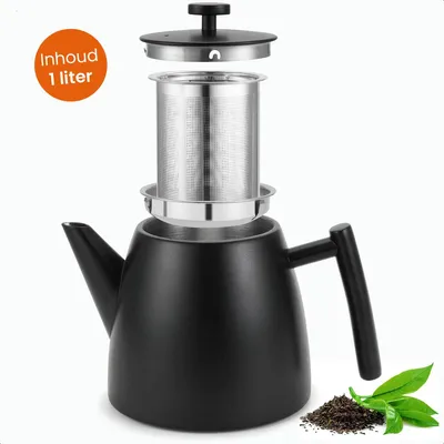 A black teapot with its infuser and lid disassembled, set against a white background with a pile of tea leaves and some fresh tea leaves in the foreground.