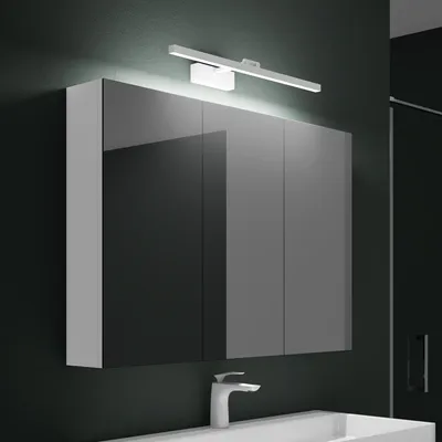 A modern bathroom vanity with a mirrored cabinet and a sleek LED light fixture above it.