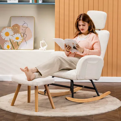 A woman is reading a book while sitting on a rocking chair with an ottoman in a living room.
