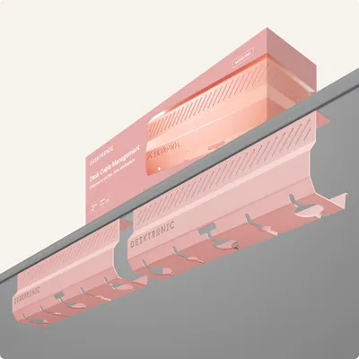 A pink cable management system attached to the underside of a desk, with its packaging box visible above.