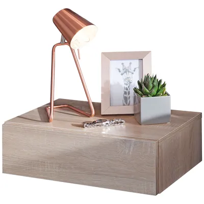 A wooden nightstand with a lamp, a framed picture, and a potted plant.