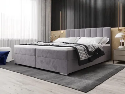 A bedroom scene featuring a bed with storage.