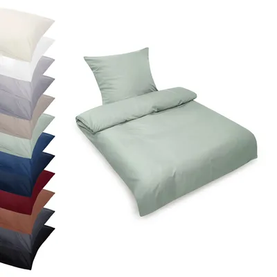 A stack of folded bedding in various colors is shown on the left, with a single set of mint green bedding displayed on the right.