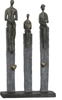 Three abstract bronze figures sit on tall, textured gray pillars, with heart-shaped pendants hanging below each figure.