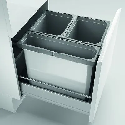 A pull-out kitchen bin system with two compartments, installed in a white cabinet.