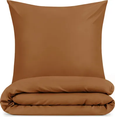 A folded duvet and a pillow are displayed against a white background.