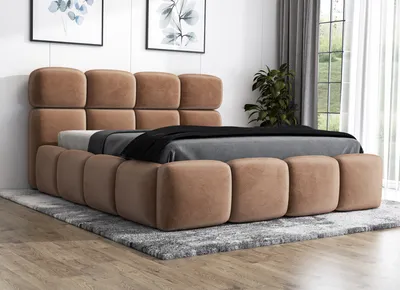 A brown upholstered bed with a mattress and bedding, placed on a rug in a room.