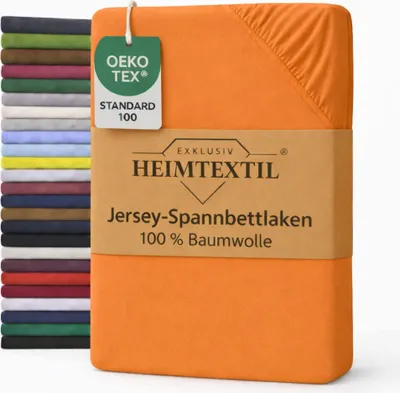 A stack of folded bed sheets in various colors is shown next to a folded orange bed sheet with a product label.