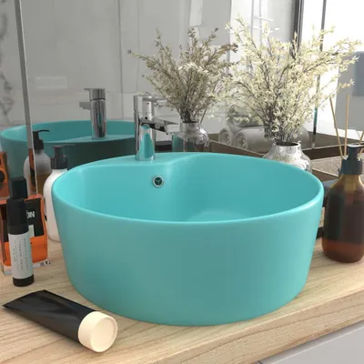 A bathroom sink with various toiletries and decorative items.