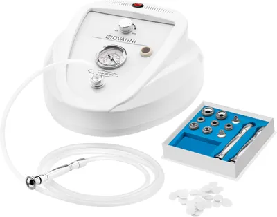 A white microdermabrasion machine with accessories on a white background.