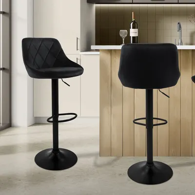 Two black bar stools are shown in a kitchen setting.