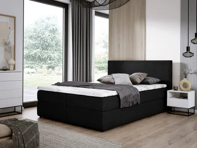 A bedroom scene with a bed, dresser, and nightstand.