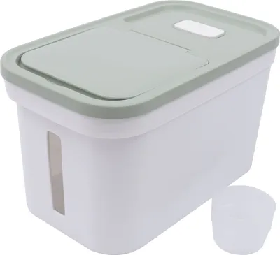 A white and light green food storage container with a clear measuring cup next to it, set against a white background.
