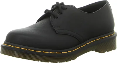 A black Dr. Martens shoe is shown from a side-angle.