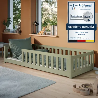 A child's bedroom with a green bed, windows, and toys.