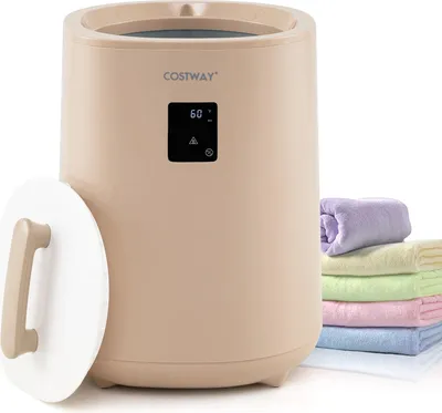A beige towel warmer with a lid off and a stack of colorful towels next to it.