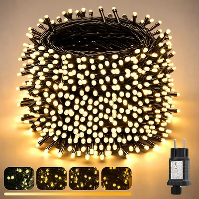 A coiled string of warm white LED lights with a black wire and a power plug.