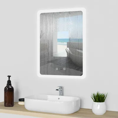 A bathroom sink with a mirror above it, showing a beach scene.