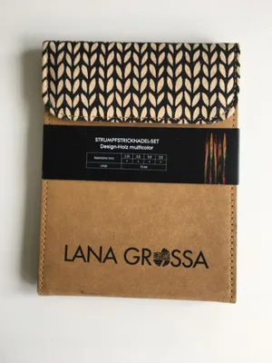A product package for knitting needles, with a patterned flap and brand logo.