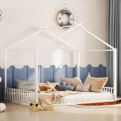 A child's bedroom with a white house-shaped bed frame, decorated with nautical-themed items.