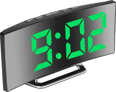A digital alarm clock with a curved mirror display showing the time.