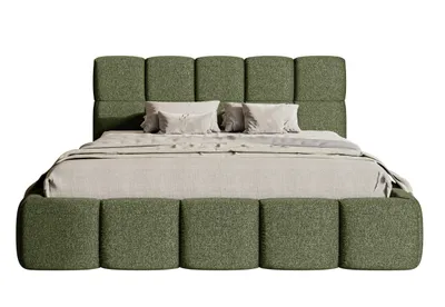 A bed with a green upholstered frame and headboard, with beige bedding and pillows.