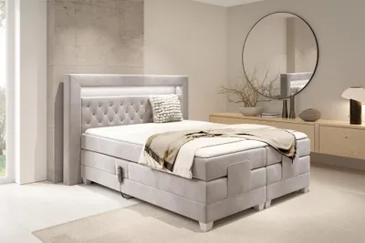 A bedroom scene with a large bed as the main focus.