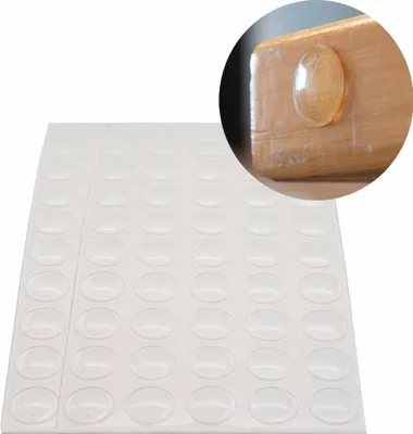 A sheet of clear adhesive bumper pads with a close-up inset showing one pad applied to the corner of a wooden surface.