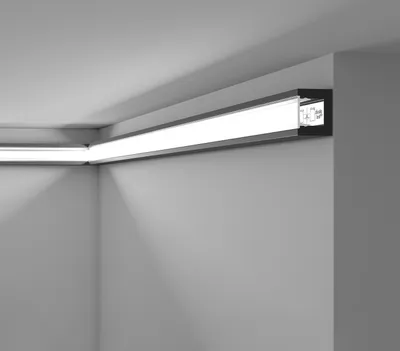 A corner of a room with a black LED light strip installed along the ceiling and wall.