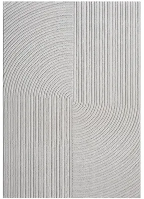 A close-up, textured view of a light gray rug with a geometric pattern of parallel lines and arcs.