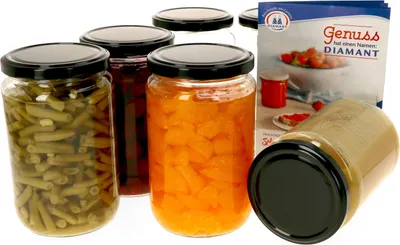 A collection of glass jars filled with food items, along with a product information leaflet.